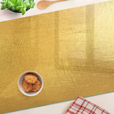 Glas-Schneidebrett mit goldfarbener, spiegelnder Oberfläche