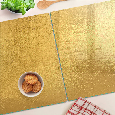 Glas-Schneidebrett mit goldfarbener, spiegelnder Oberfläche