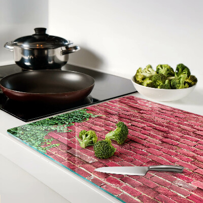 Schneidebrett Glas mit Motiv einer Ziegelmauer und Vegetation