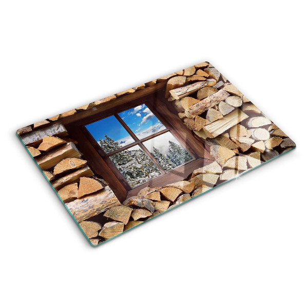 Glas-Schneidebrett mit Motiv einer Winterlandschaft, sichtbar durch ein Fenster