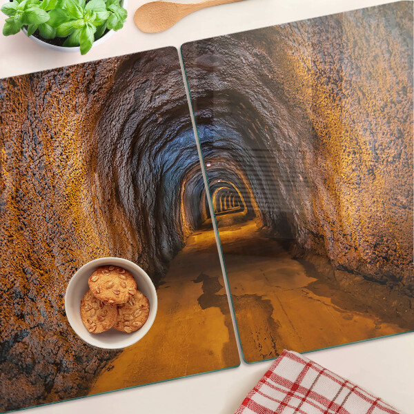 Schneidebrett Glas mit Motiv eines beleuchteten Tunnels in einer Höhle