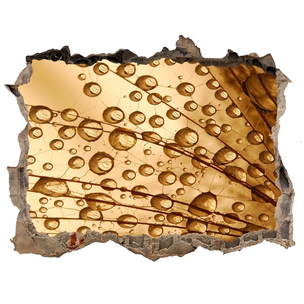 Wandtattoos Mauerdurchbruch Ein goldener Tropfen auf dem Betonhintergrund