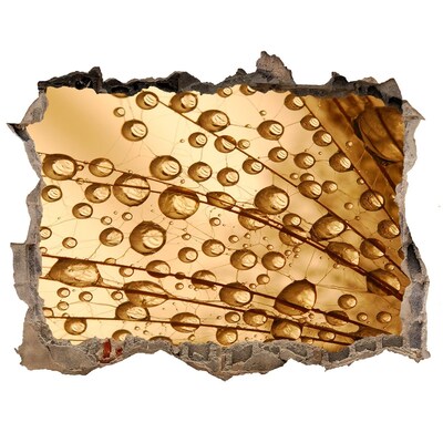 Wandtattoos Mauerdurchbruch Ein goldener Tropfen auf dem Betonhintergrund