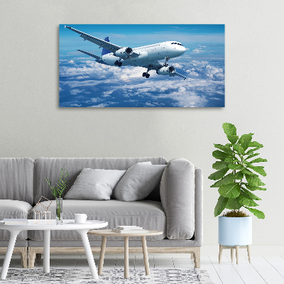 Bild auf leinwand Ein Flugzeug in den Wolken