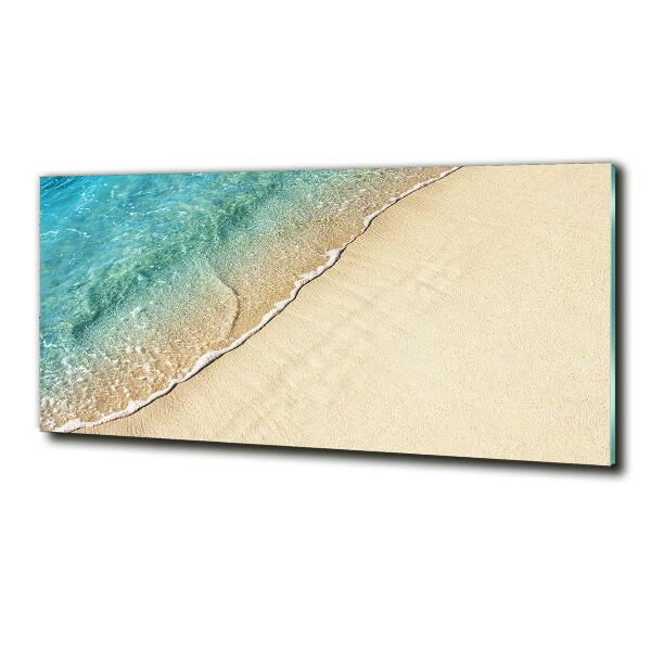 Glasbild Eine Welle am Strand