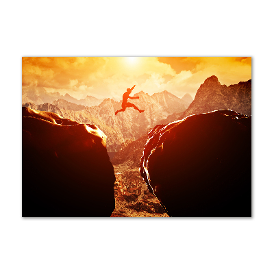 Glasbild Spring über den Abgrund