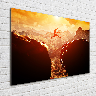 Glasbild Spring über den Abgrund