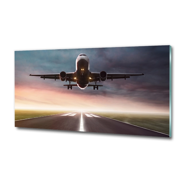 Glasbild Ein Flugzeug startet