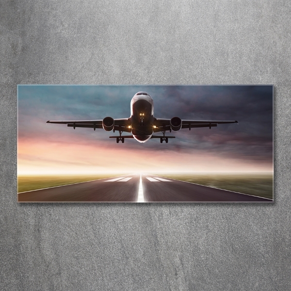 Glasbild Ein Flugzeug startet