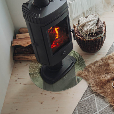 Runde Glasplatte für Kaminofen Tropische Blätter im Hintergrund