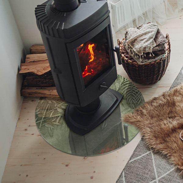 Runde Glasplatte für Kaminofen Tropische Blätter im Hintergrund