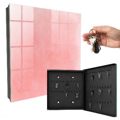 Schlüsselbox für die Wand mit rosa Hintergrund