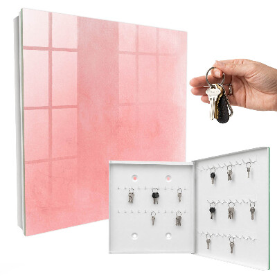 Schlüsselbox für die Wand mit rosa Hintergrund