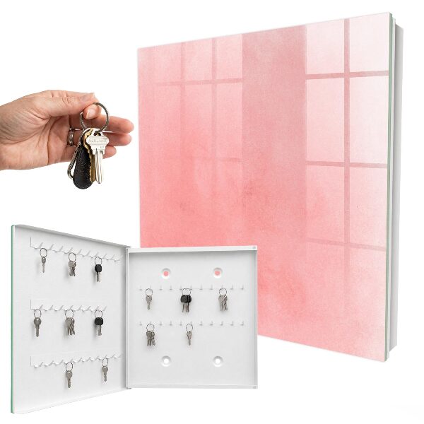 Schlüsselbox für die Wand mit rosa Hintergrund