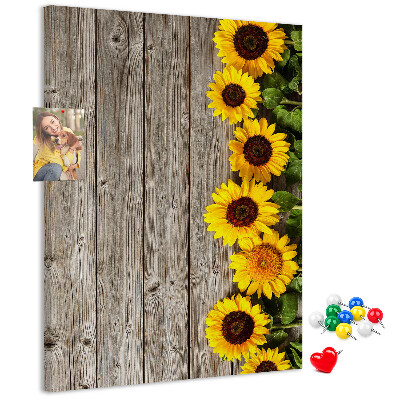 Kork-Pinnwand mit Sonnenblumen auf Holzbrett-Hintergrund