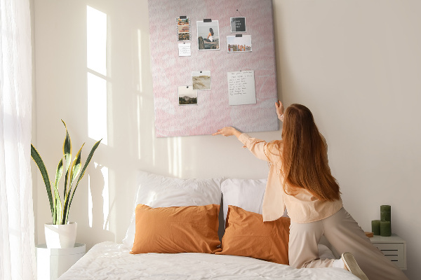 Pinnwand mit Motiv von zarten rosa Rosen im Hintergrund