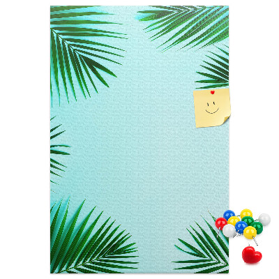 Korkpinnwand mit Palmenblätter-Motiv auf blauem Hintergrund