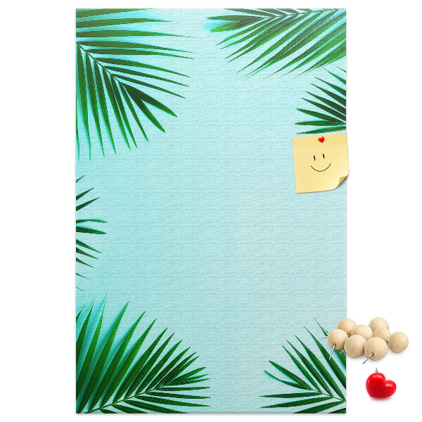 Korkpinnwand mit Palmenblätter-Motiv auf blauem Hintergrund