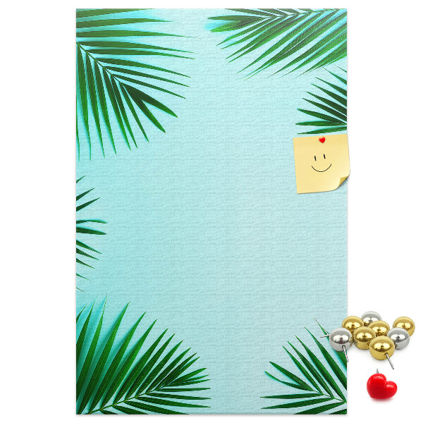 Korkpinnwand mit Palmenblätter-Motiv auf blauem Hintergrund