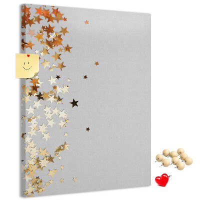 Pinnwand mit goldenen und silbernen Sternen auf grauem Grund