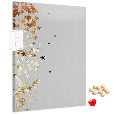 Pinnwand mit goldenen und silbernen Sternen auf grauem Grund