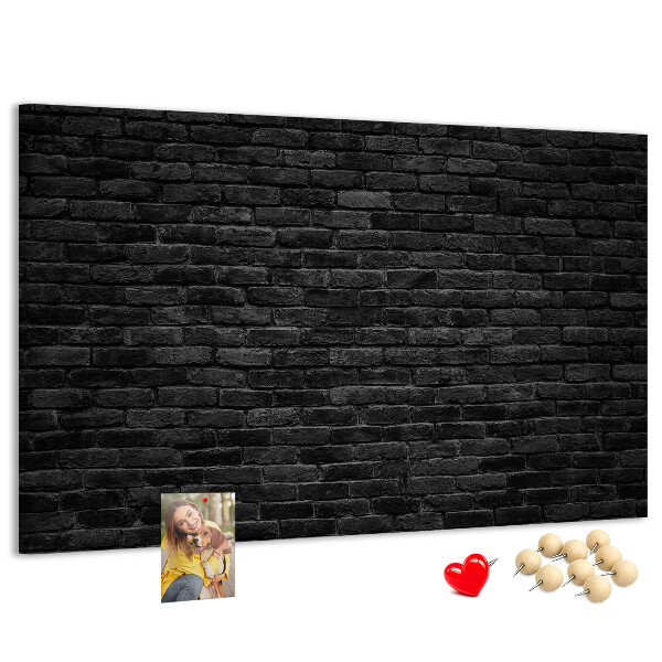Bild mit Korkrückwand Nahaufnahme einer dunklen strukturierten Backsteinwand