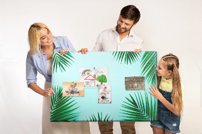 Korktafel mit tropischen Blättern auf blauem Hintergrund