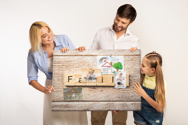 Korktafel mit Motiv einer Familie vor einem Holzbrett