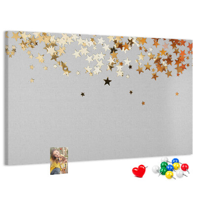 Korkbild mit goldenen Sternen auf grauem Hintergrund