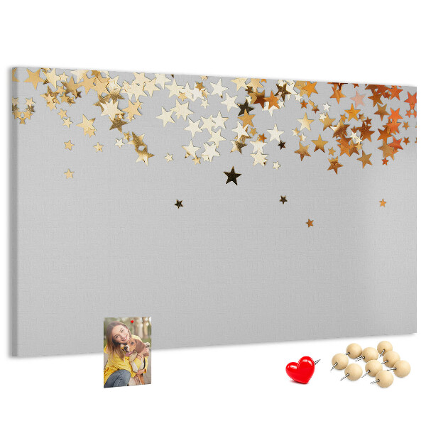 Korkbild mit goldenen Sternen auf grauem Hintergrund