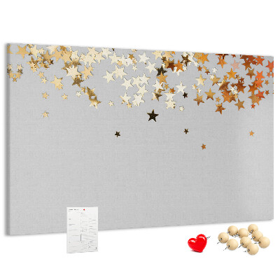 Korkbild mit goldenen Sternen auf grauem Hintergrund