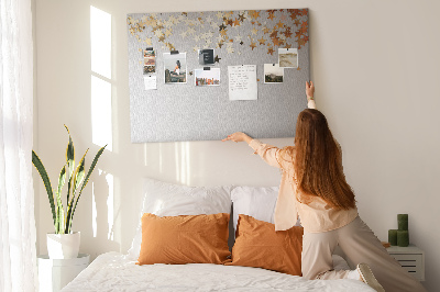 Korkbild mit goldenen Sternen auf grauem Hintergrund