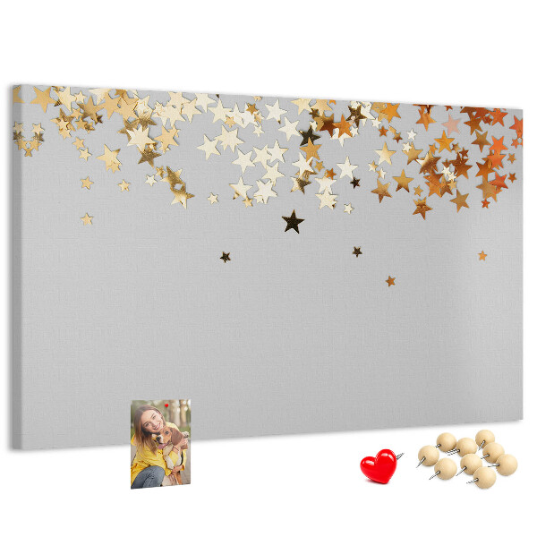Korkbild mit goldenen Sternen auf grauem Hintergrund