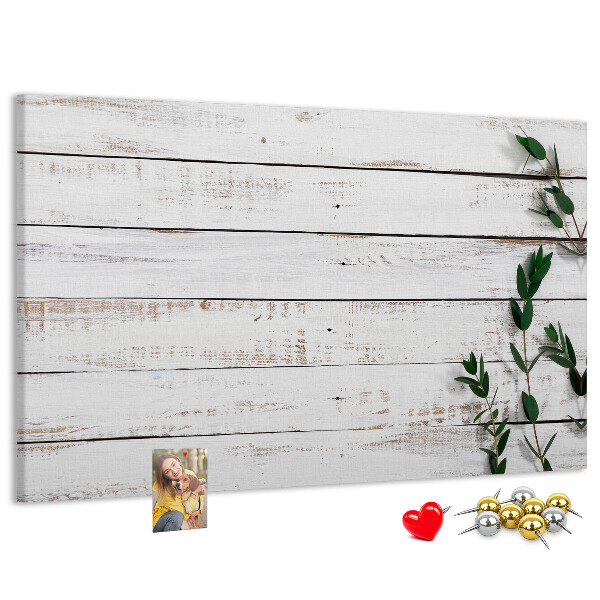 Korktafel mit rustikalem Holzrahmen und grünen Zweigen