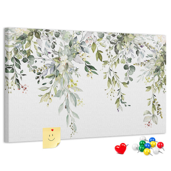 Korktafel mit Motiv aus grünen Blättern und zarten Blüten