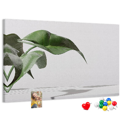 Kork-Pinnwand zarte Blätter auf minimalistischem Hintergrund