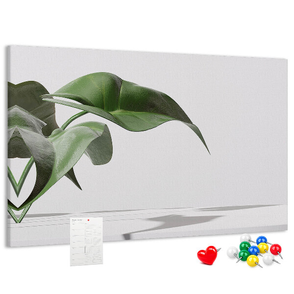 Kork-Pinnwand zarte Blätter auf minimalistischem Hintergrund