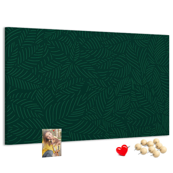Korktafel mit Motiv grüne Blätter auf dunklem Hintergrund