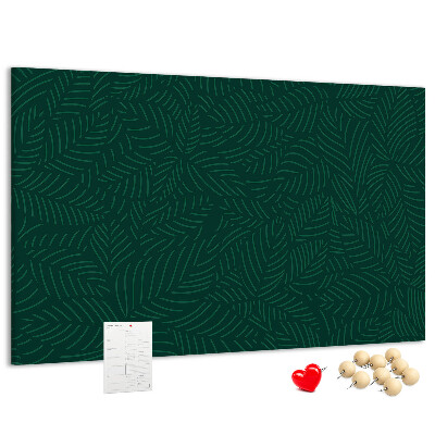 Korktafel mit Motiv grüne Blätter auf dunklem Hintergrund