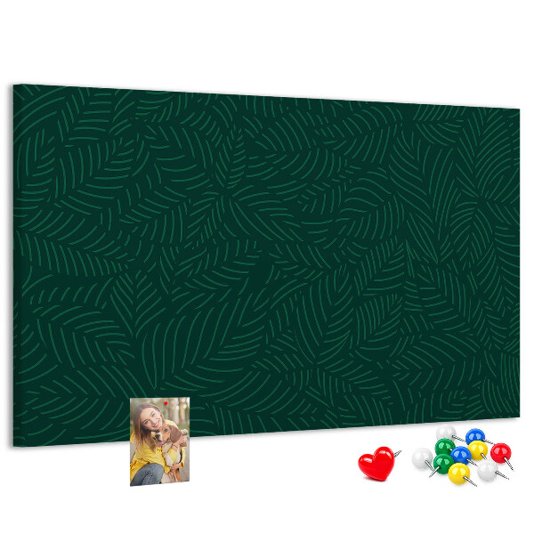 Korktafel mit Motiv grüne Blätter auf dunklem Hintergrund
