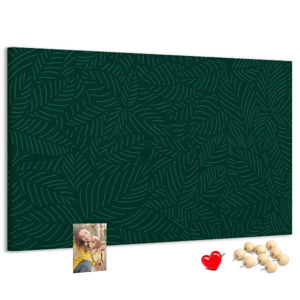 Korktafel mit Motiv grüne Blätter auf dunklem Hintergrund