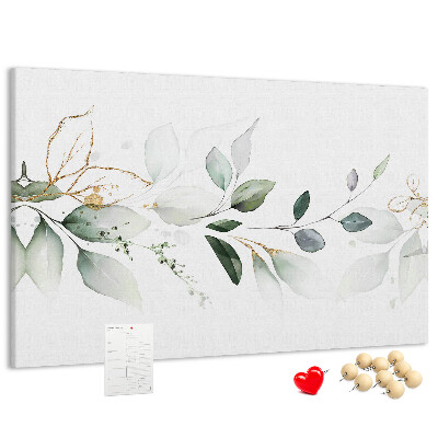 Korktafel mit zarten Blättern und goldenen Akzenten