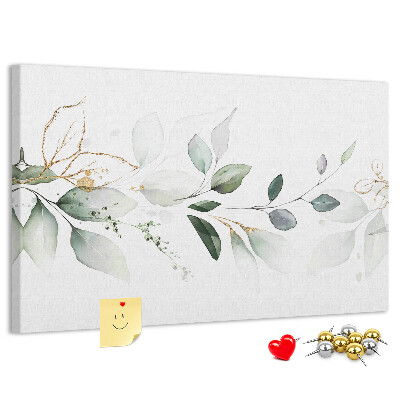 Korktafel mit zarten Blättern und goldenen Akzenten