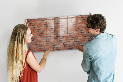 Schreib magnettafel Eine Notiztafel an einer Backsteinmauer