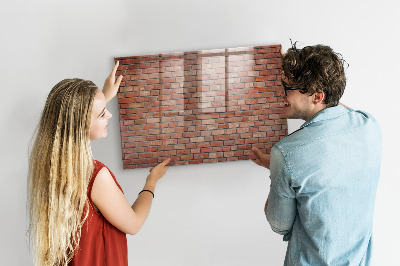 Schreib magnettafel Eine Notiztafel an einer Backsteinmauer